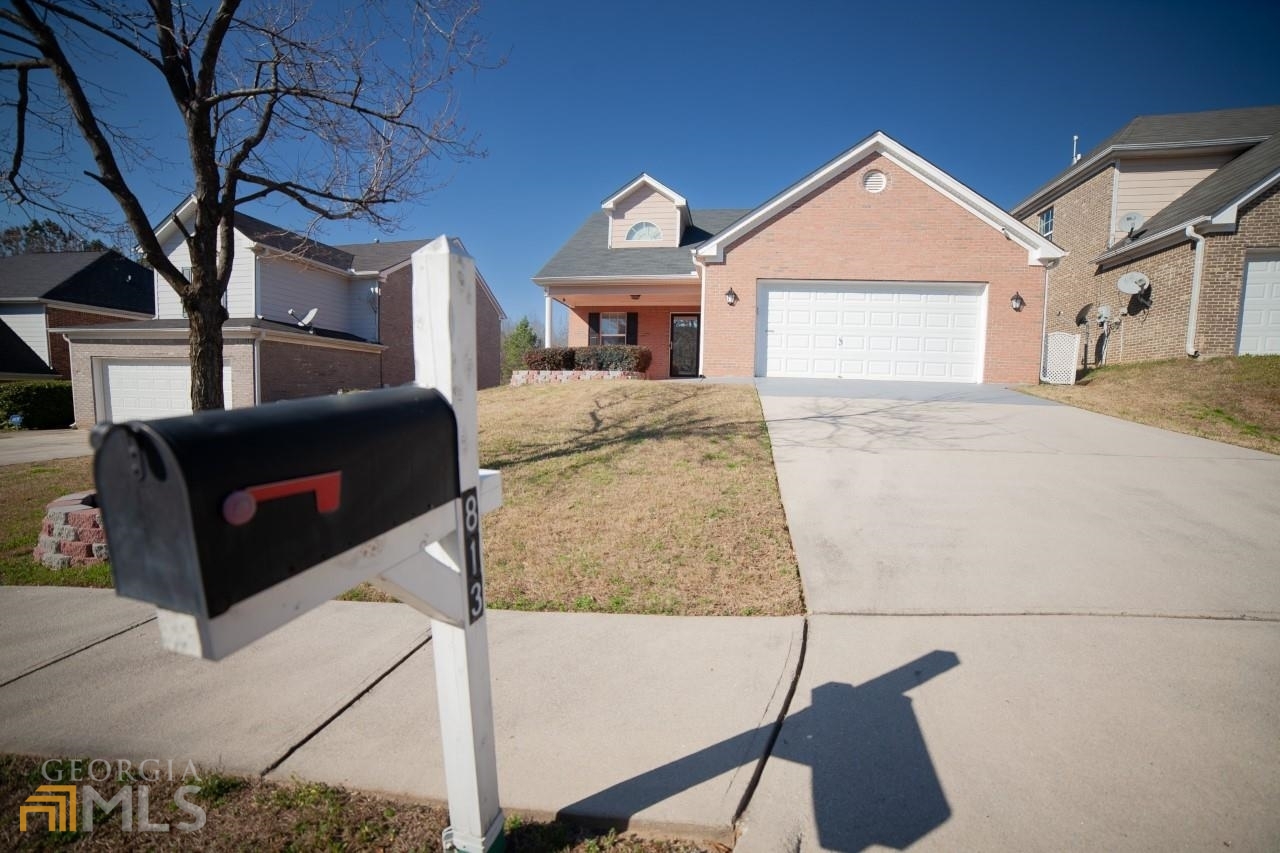 813 Winsap Drive, Unit 168 Stockbridge, GA 30281 - Photo 1 of 1 a front view of a house with a yard