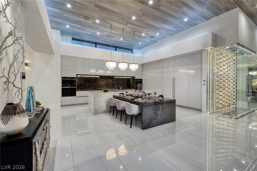 611 Cityview Ridge Drive Henderson, NV 89012 - Photo 23 of 66 Gleaming tile floors and a wood-paneled ceiling frame this ultra-modern kitchen space.