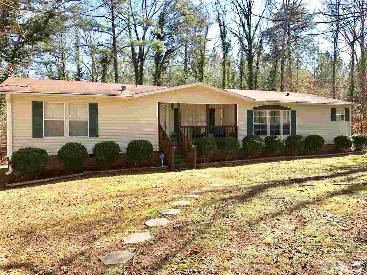 6916 Matthews Road Durham, NC 27712 - Photo 1 of 24 a front view of a house with garden