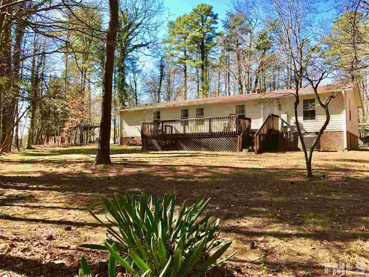 6916 Matthews Road Durham, NC 27712 - Photo 23 of 24 a view of a house with a yard
