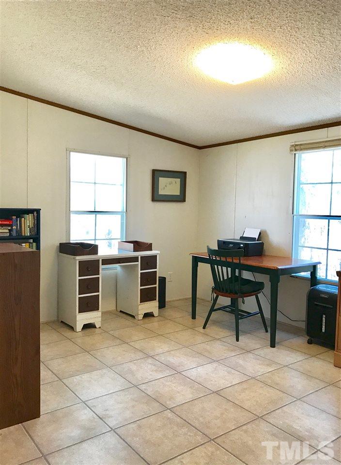 6916 Matthews Road Durham, NC 27712 - Photo 7 of 24 a workspace with furniture window and outside view