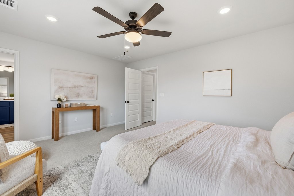 8001 Andravida Drive Austin, TX 78747 - Photo 20 of 35 Comfortable primary retreat with ceiling fan and soft finishes