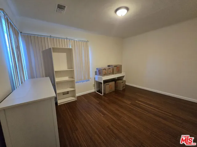 a room with wooden floor and furniture