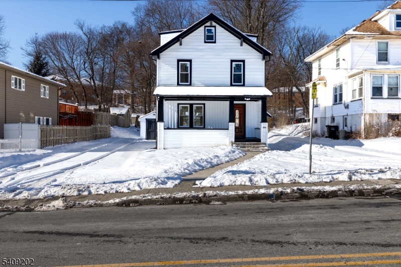 431 North Main Street Wharton, NJ 07885 - Photo 2 of 47 a view of a white house with a yard covered in snow