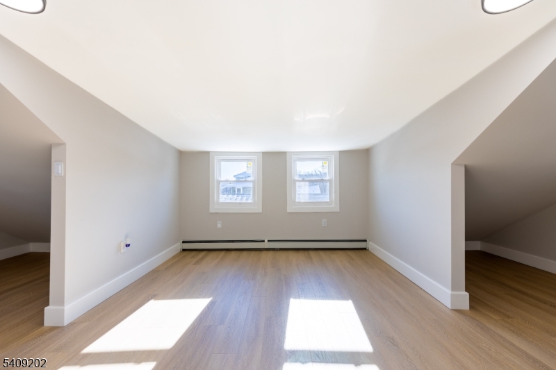 431 North Main Street Wharton, NJ 07885 - Photo 23 of 47 an empty room with wooden floor and windows