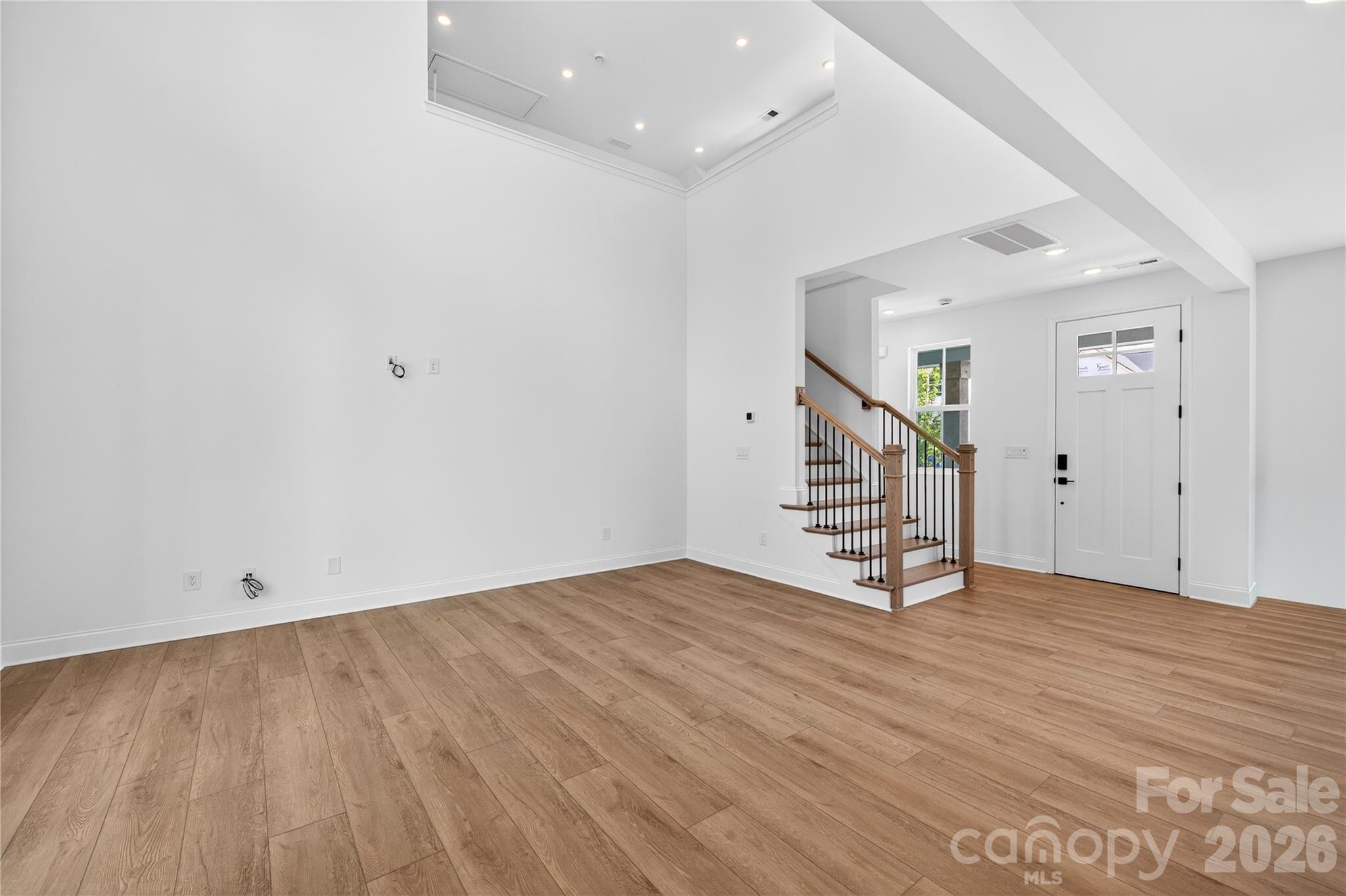 409 Celestial Drive Tega Cay, SC 29708 - Photo 8 of 10 a view of an empty room with wooden floor and stairs