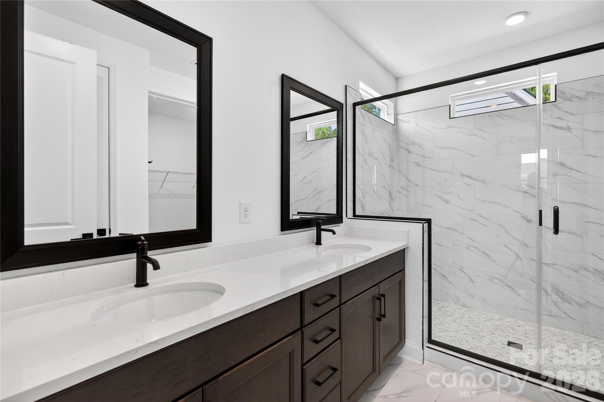 409 Celestial Drive Tega Cay, SC 29708 - Photo 10 of 10 a bathroom with a double vanity sink and mirror