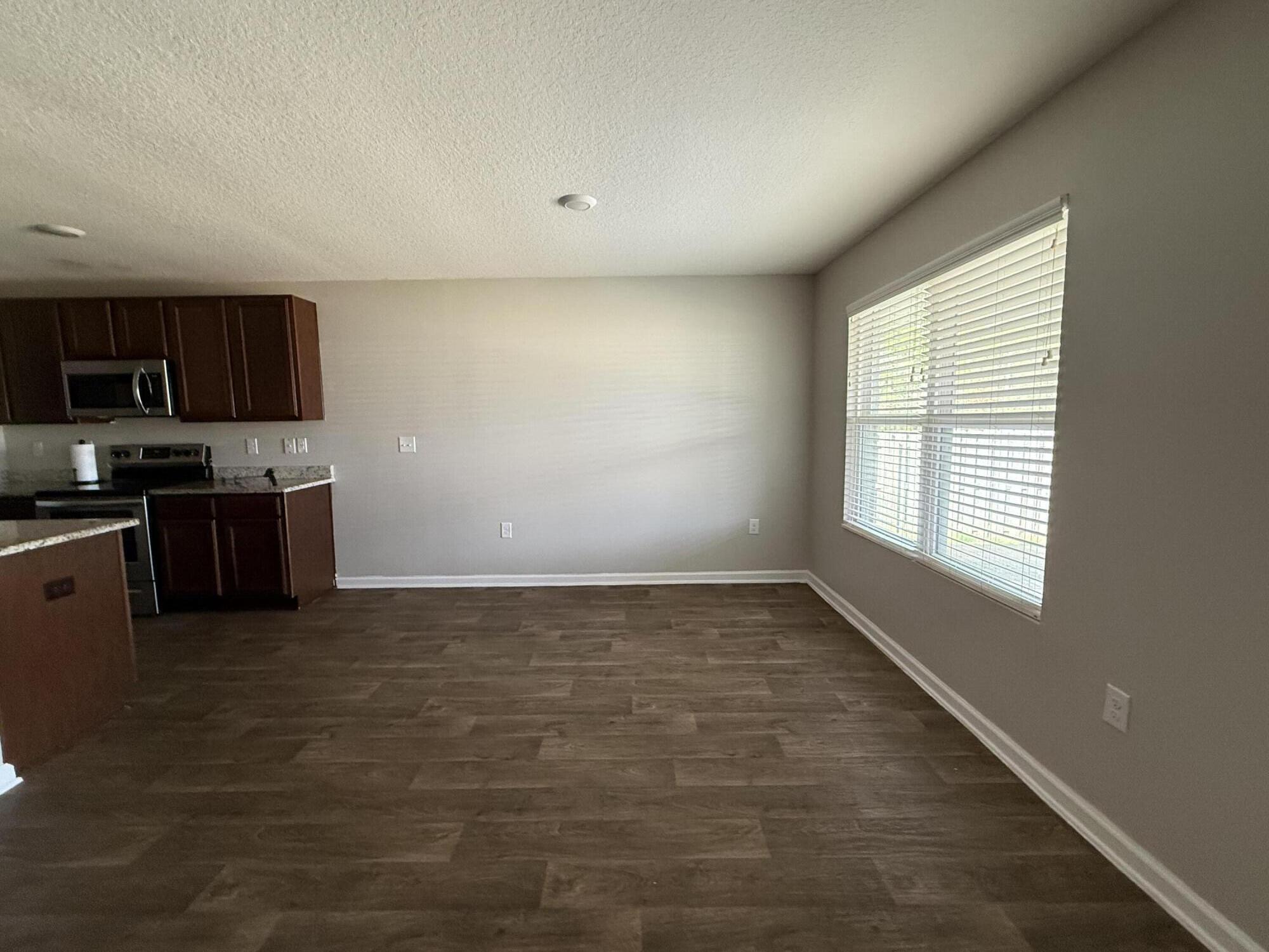 1004 Limpkin Street Crestview, FL 32539 - Photo 18 of 31 a view of kitchen with kitchen island a sink wooden floor and a stove top oven