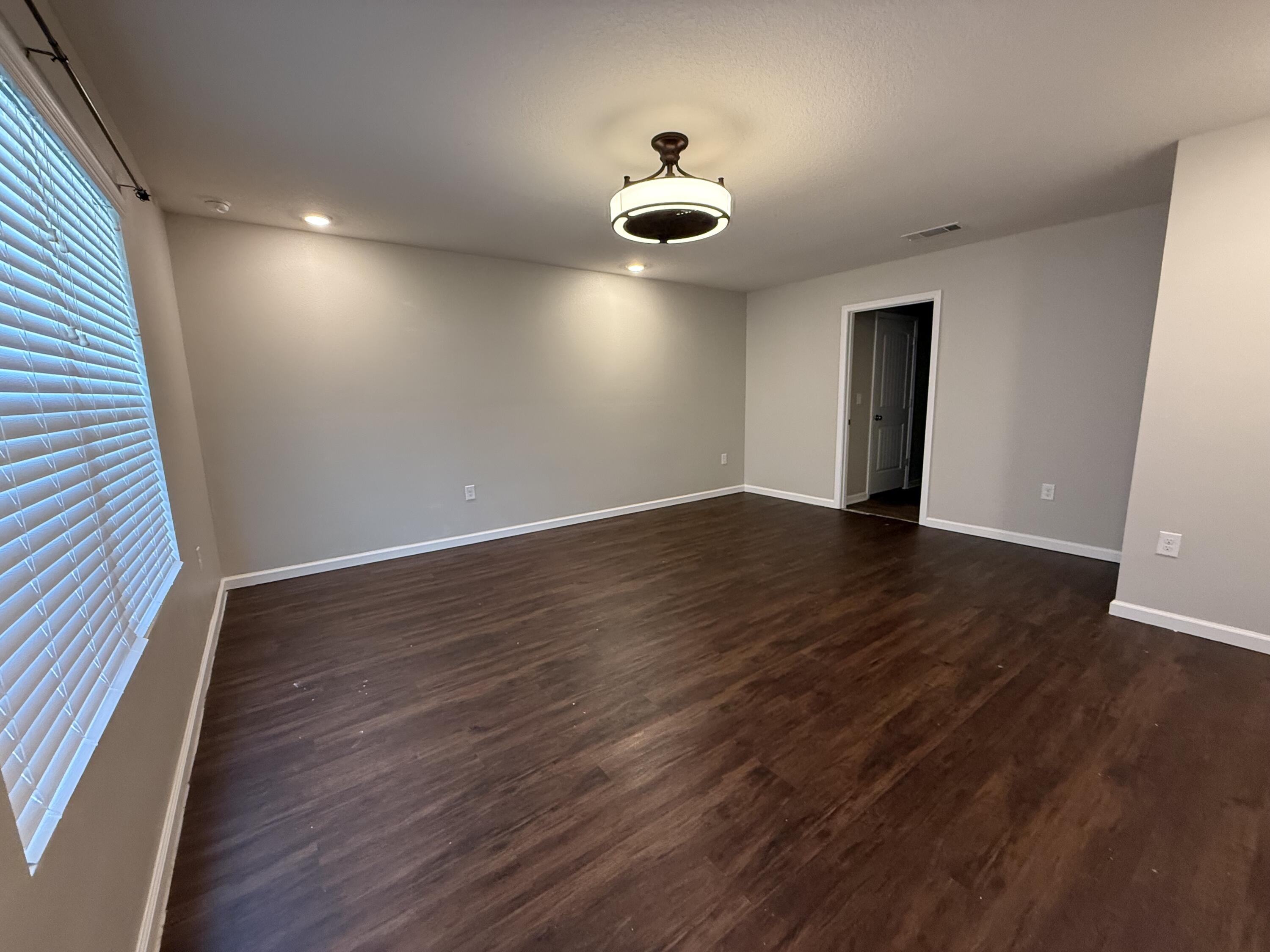1004 Limpkin Street Crestview, FL 32539 - Photo 20 of 31 an empty room with wooden floor and windows