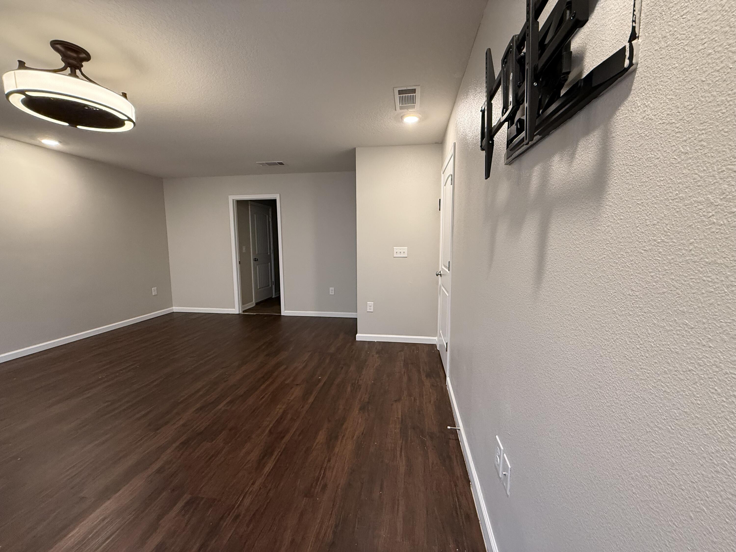 1004 Limpkin Street Crestview, FL 32539 - Photo 21 of 31 a view of a hallway with wooden floor