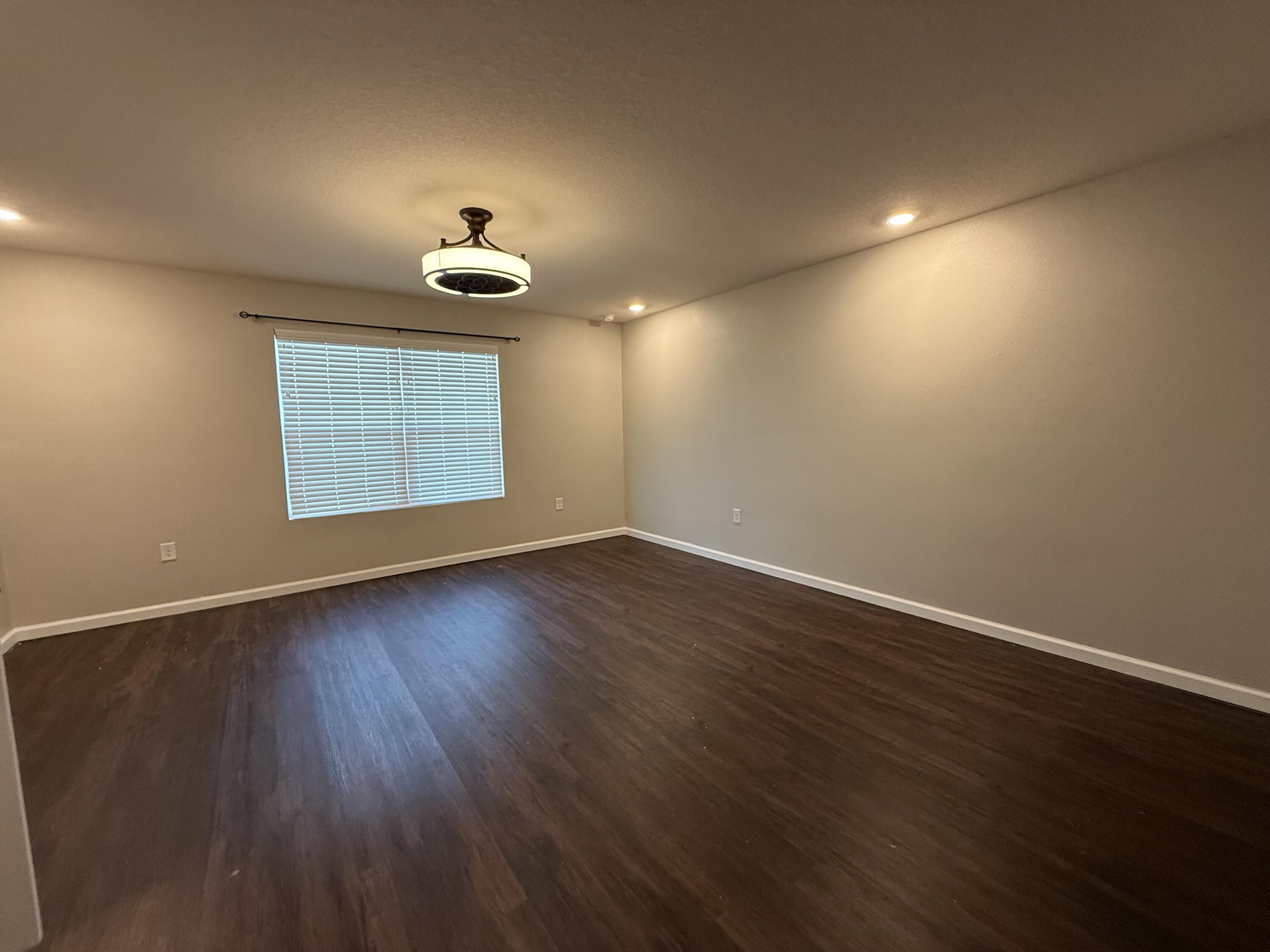 1004 Limpkin Street Crestview, FL 32539 - Photo 22 of 31 a view of an empty room with wooden floor and a window