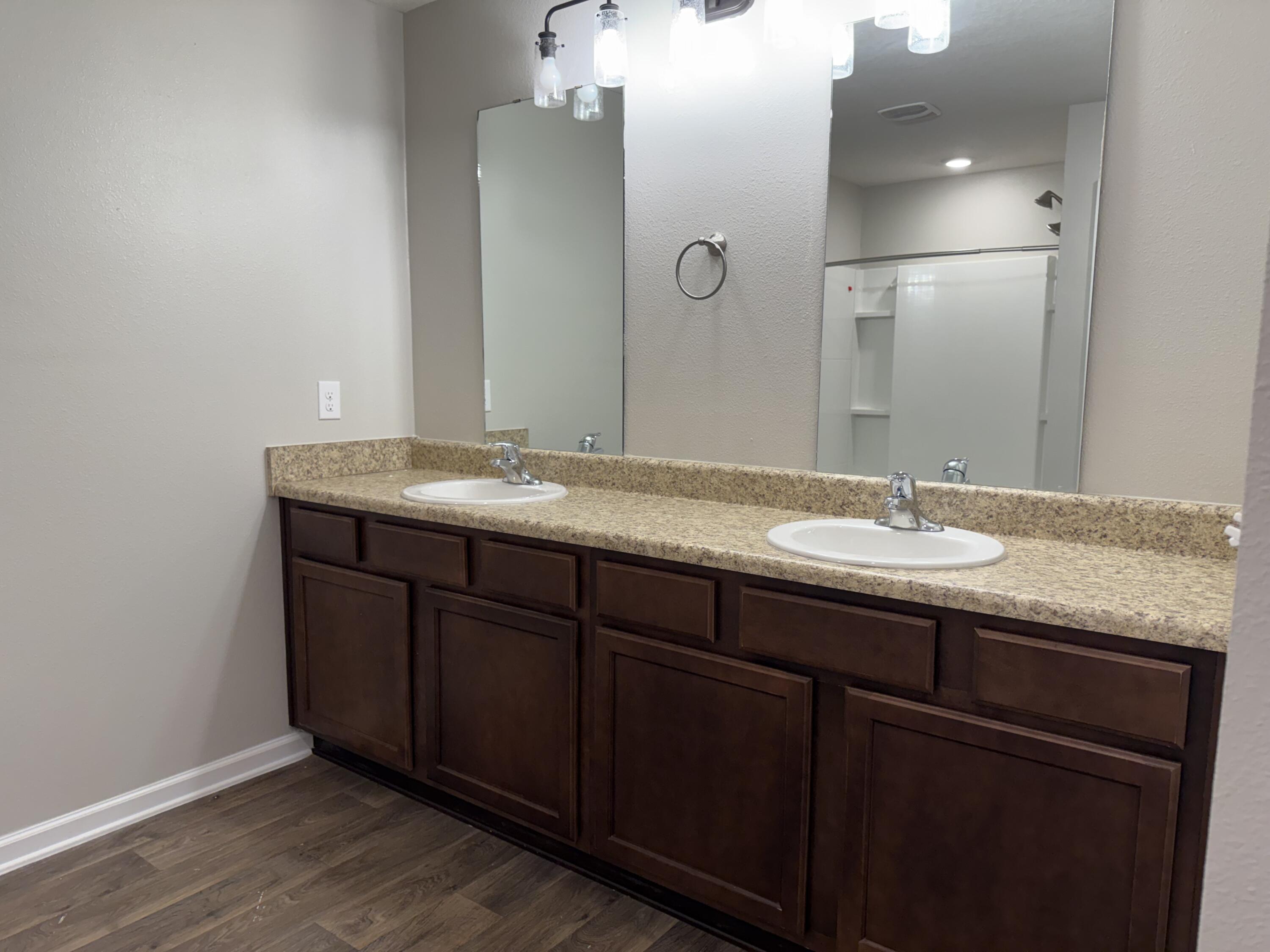 1004 Limpkin Street Crestview, FL 32539 - Photo 24 of 31 a bathroom with a granite countertop sink and a mirror