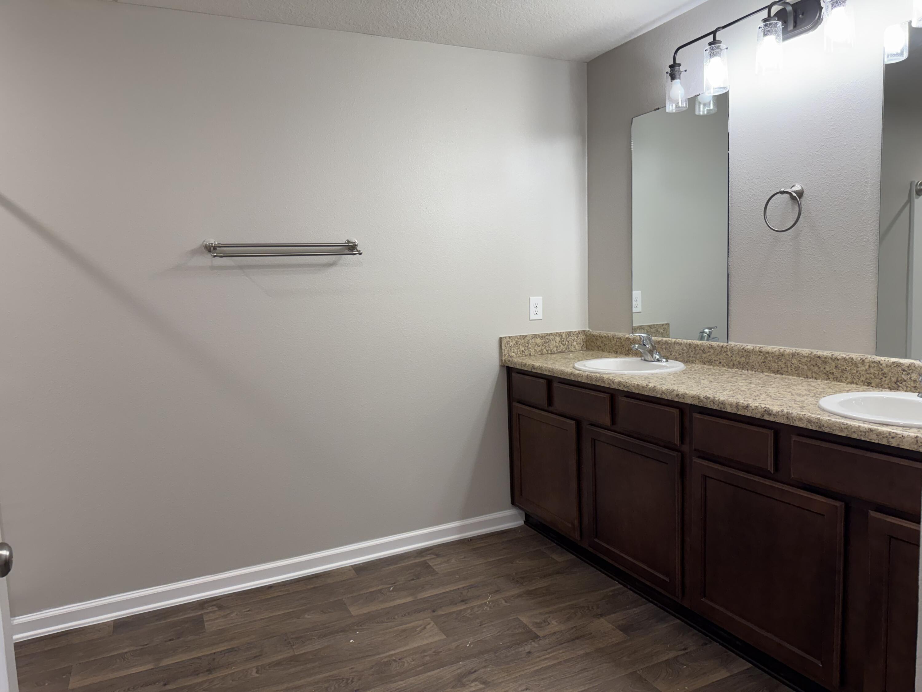 1004 Limpkin Street Crestview, FL 32539 - Photo 25 of 31 a bathroom with a granite countertop sink and a mirror