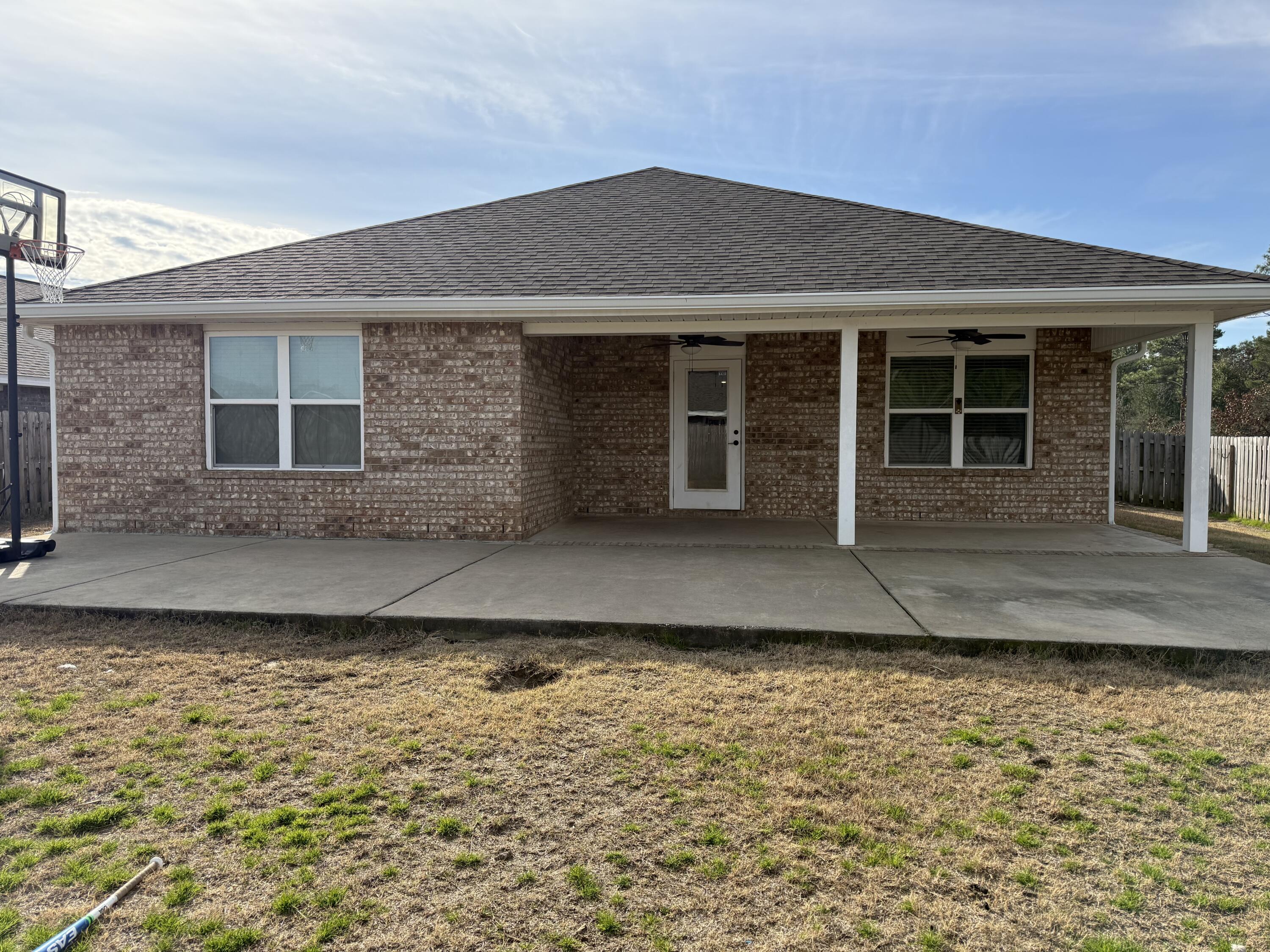1004 Limpkin Street Crestview, FL 32539 - Photo 27 of 31 a front view of a house with a yard