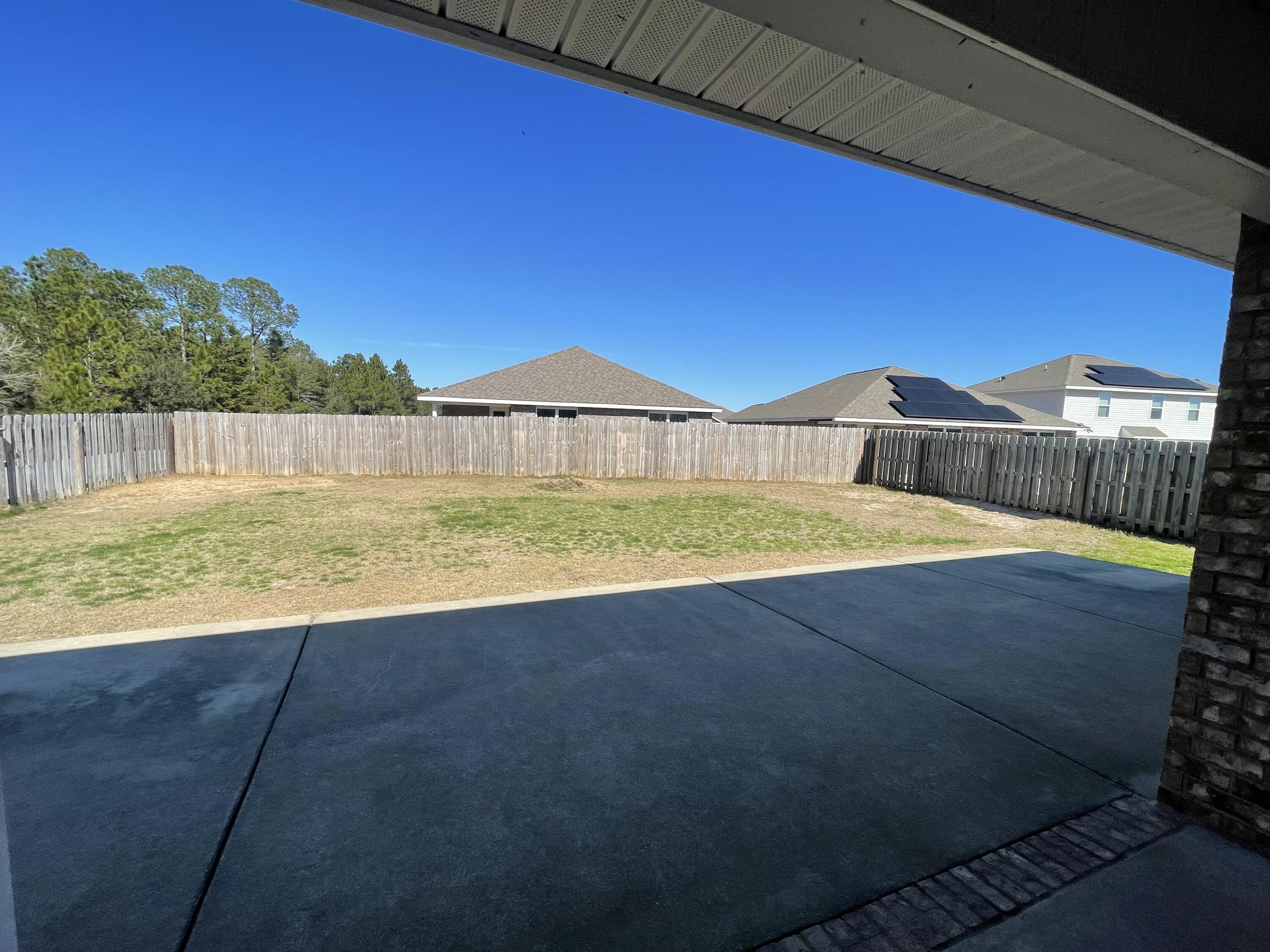 1004 Limpkin Street Crestview, FL 32539 - Photo 31 of 31 a view of a swimming pool with a yard and a fire pit