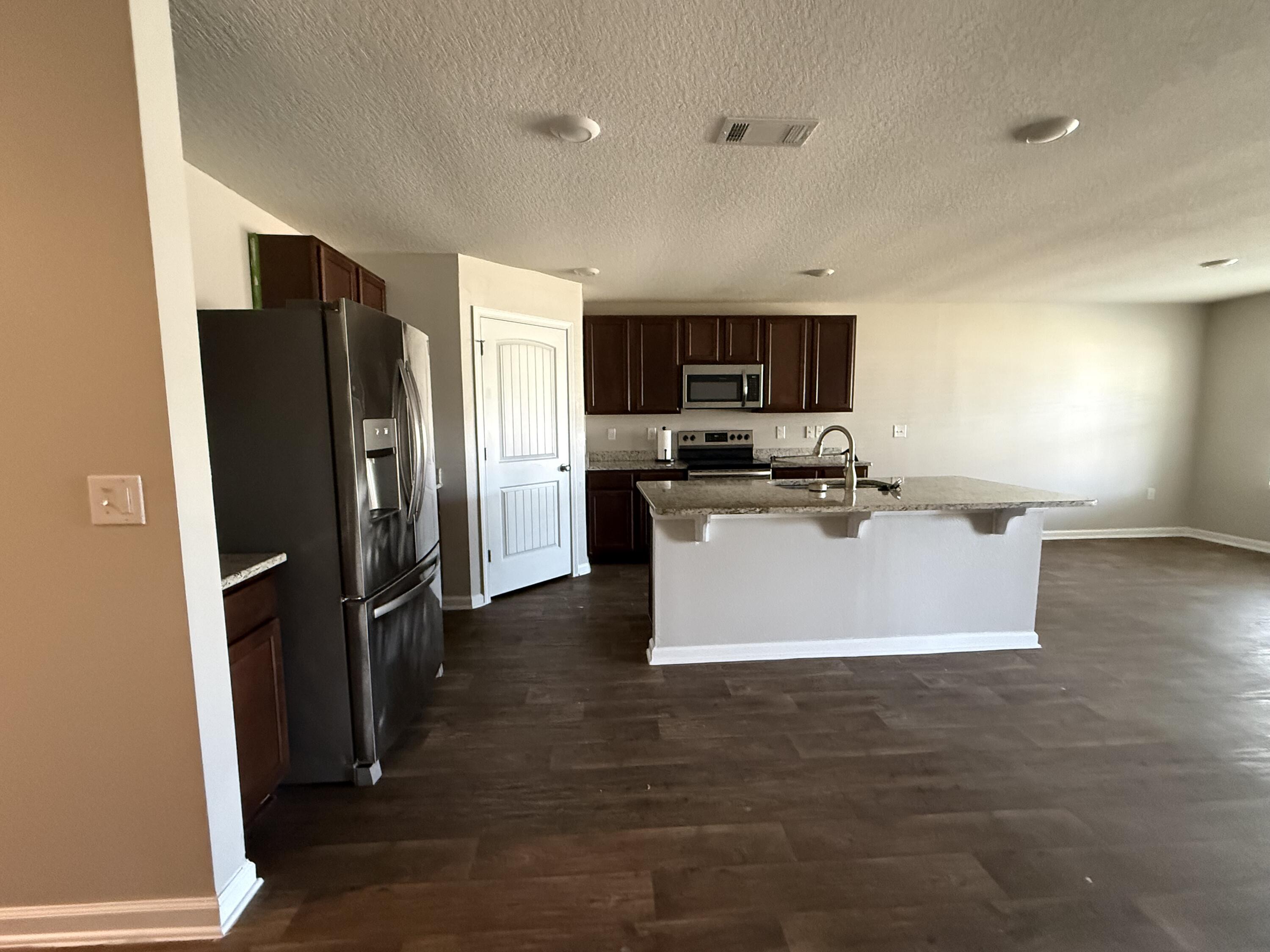 1004 Limpkin Street Crestview, FL 32539 - Photo 8 of 31 a kitchen with stainless steel appliances a refrigerator sink and microwave