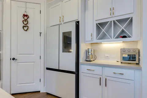 a kitchen with kitchen island stainless steel appliances a sink stove and cabinets
