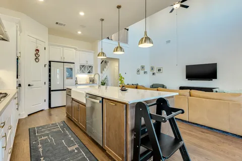a kitchen with stainless steel appliances granite countertop a sink stove and refrigerator