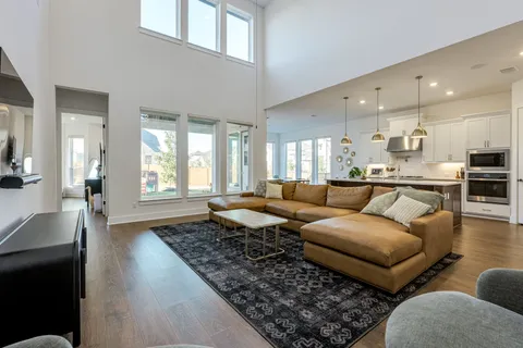 a bedroom with a bed furniture and a large window