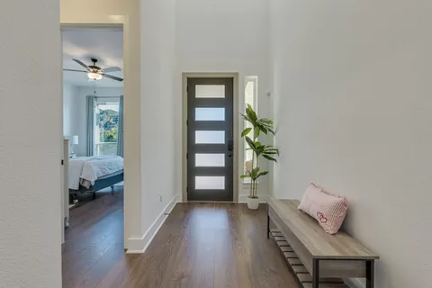 a hallway with wooden floor and furniture