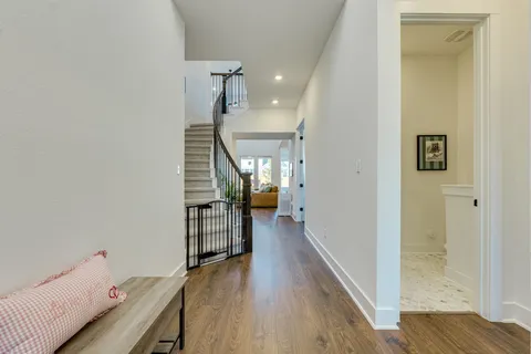 a view of a room with wooden floor and stairs