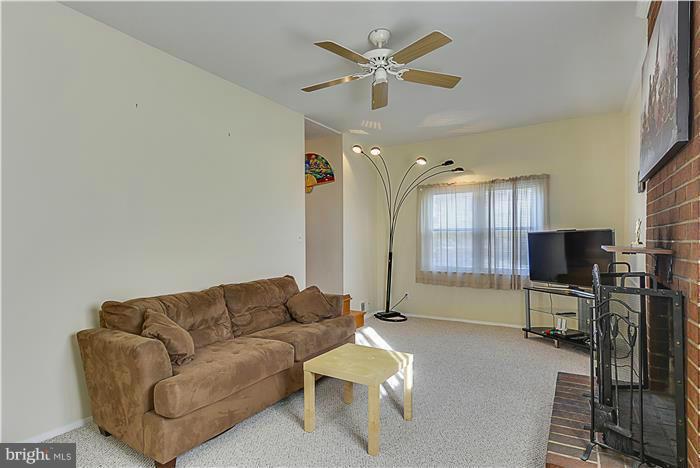 1307 Gresham Road Silver Spring, MD 20904 - Photo 11 of 22 a living room with furniture a ceiling fan and a rug