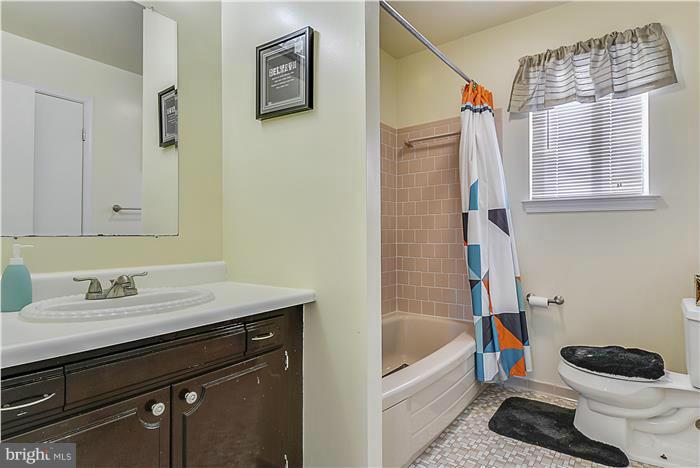 1307 Gresham Road Silver Spring, MD 20904 - Photo 17 of 22 a bathroom with a granite countertop sink a toilet a bathtub and shower