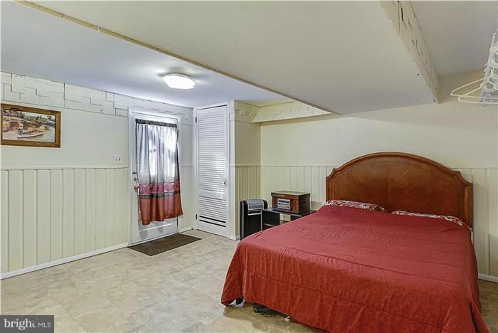 1307 Gresham Road Silver Spring, MD 20904 - Photo 20 of 22 a bedroom with a bed and a large mirror