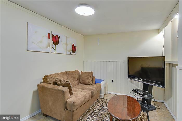 1307 Gresham Road Silver Spring, MD 20904 - Photo 21 of 22 a living room with furniture and a flat screen tv