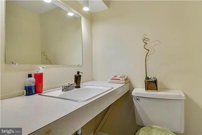 1307 Gresham Road Silver Spring, MD 20904 - Photo 22 of 22 a bathroom with a sink a toilet and a mirror