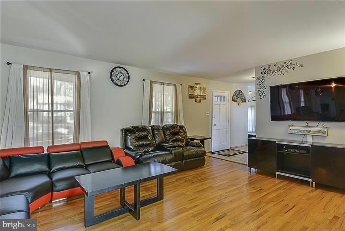 1307 Gresham Road Silver Spring, MD 20904 - Photo 4 of 22 a living room with furniture and a flat screen tv