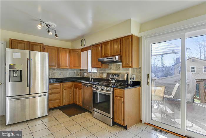 1307 Gresham Road Silver Spring, MD 20904 - Photo 8 of 22 a kitchen with stainless steel appliances granite countertop a stove a refrigerator and a sink