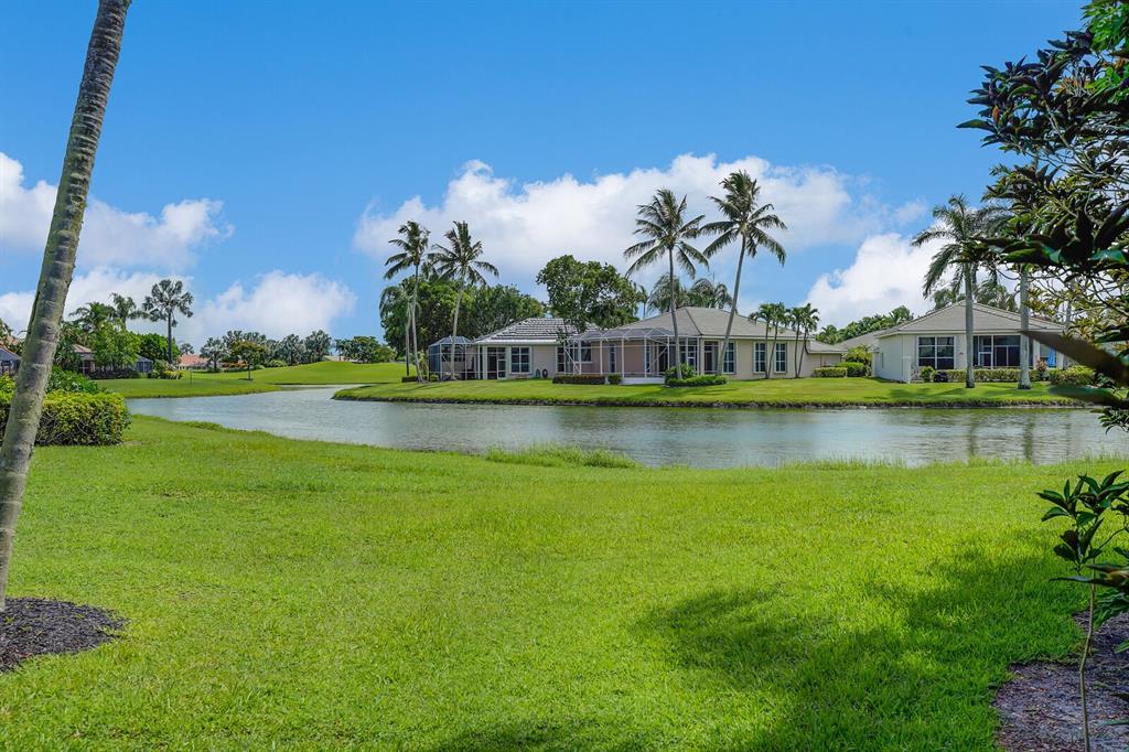 7955 Rockford Road Boynton Beach, FL 33472 - Photo 1 of 22 a view of a garden with a building in the background