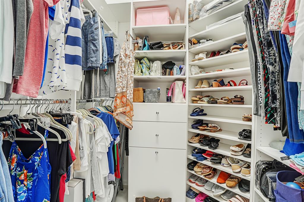 7955 Rockford Road Boynton Beach, FL 33472 - Photo 18 of 22 a view of walk in closet with clothes and shoes