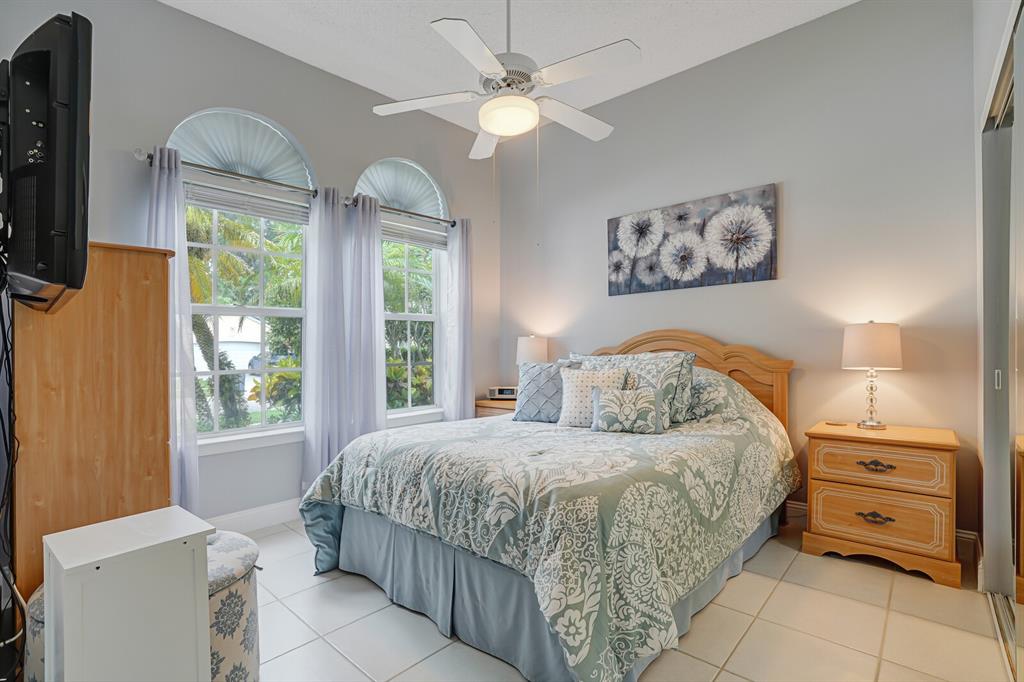 7955 Rockford Road Boynton Beach, FL 33472 - Photo 4 of 22 a bedroom with a bed and a chandelier