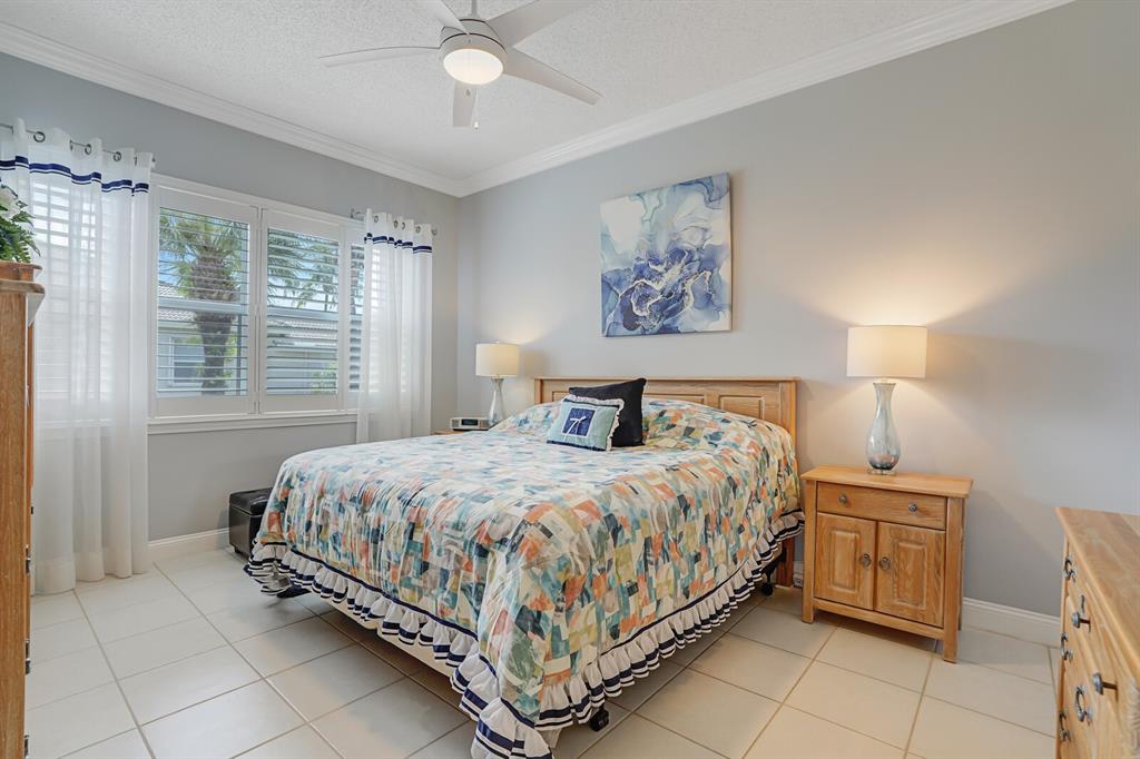 7955 Rockford Road Boynton Beach, FL 33472 - Photo 7 of 22 a bedroom with a bed and a painting on the wall
