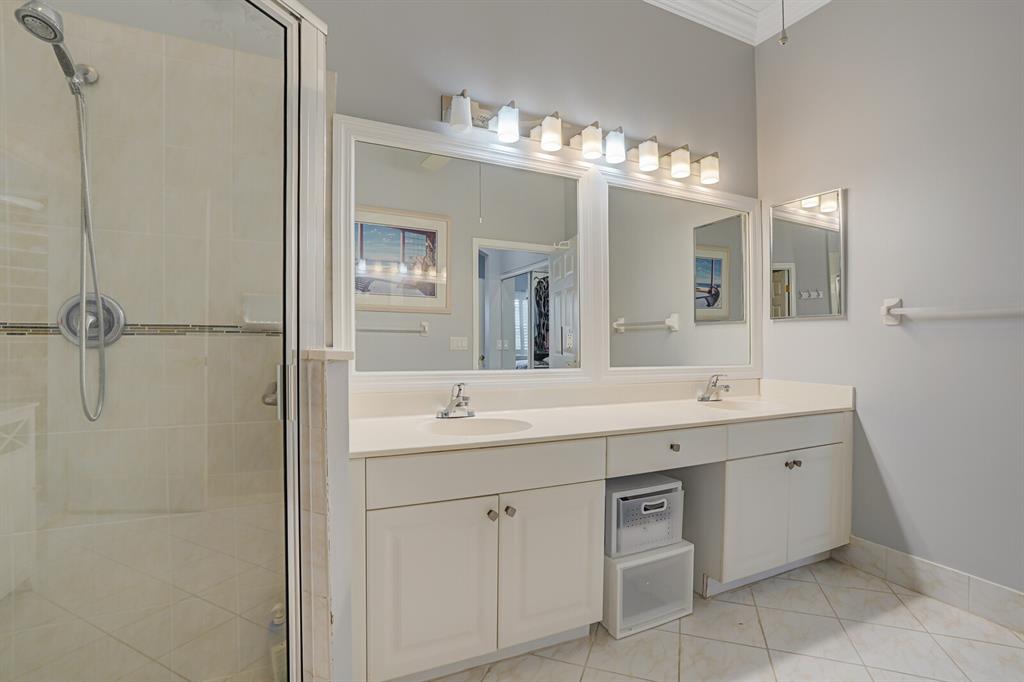 7955 Rockford Road Boynton Beach, FL 33472 - Photo 9 of 22 a spacious bathroom with a double vanity sink a mirror and a shower