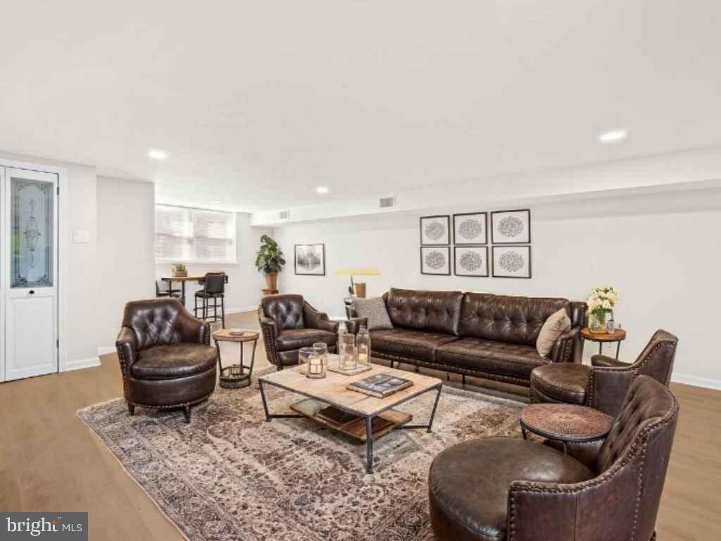 5613 Chelwynd Road Baltimore, MD 21227 - Photo 14 of 38 a living room with furniture and wooden floor