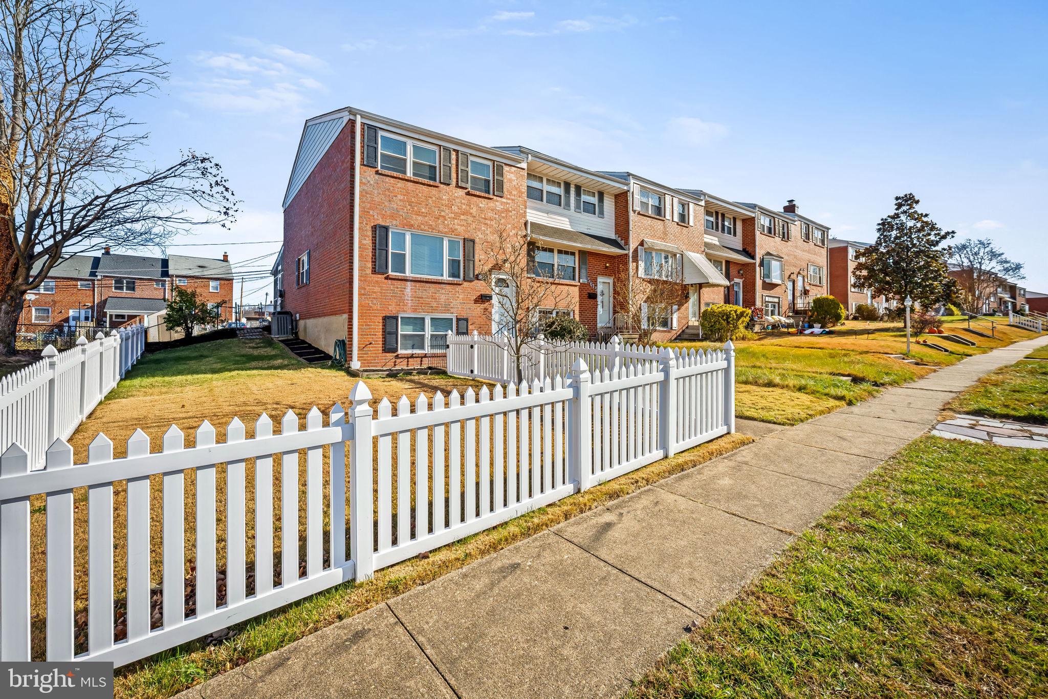 5613 Chelwynd Road Baltimore, MD 21227 - Photo 2 of 38 a view of a building with a yard