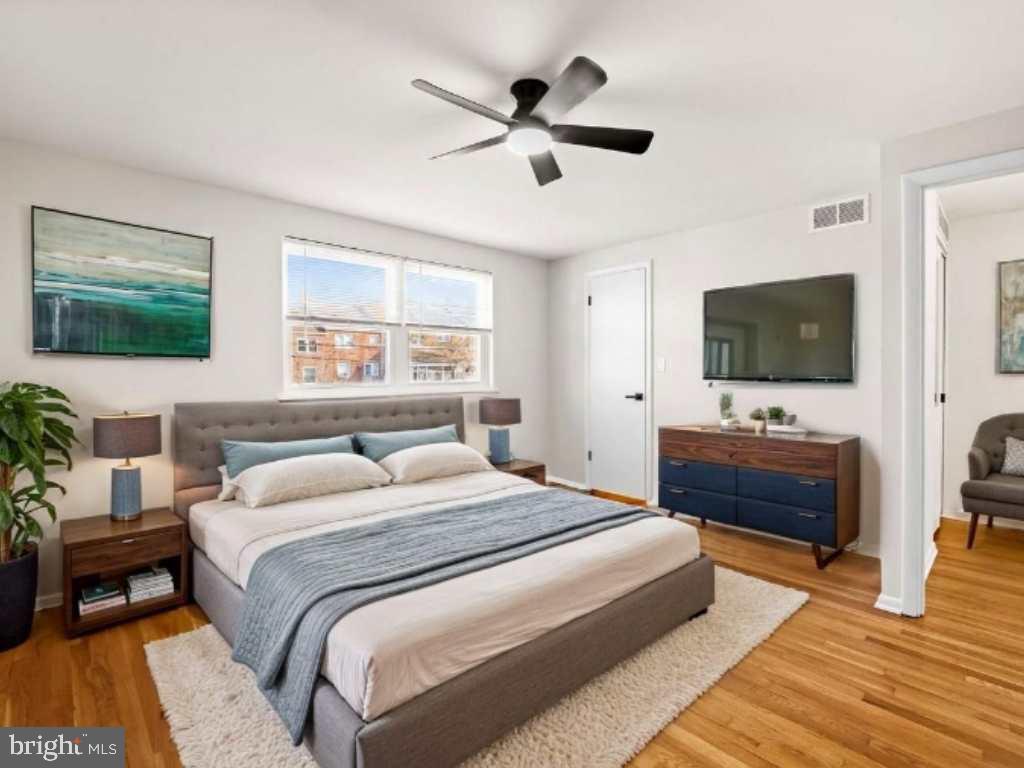 5613 Chelwynd Road Baltimore, MD 21227 - Photo 24 of 38 a bedroom with a bed and a flat screen tv