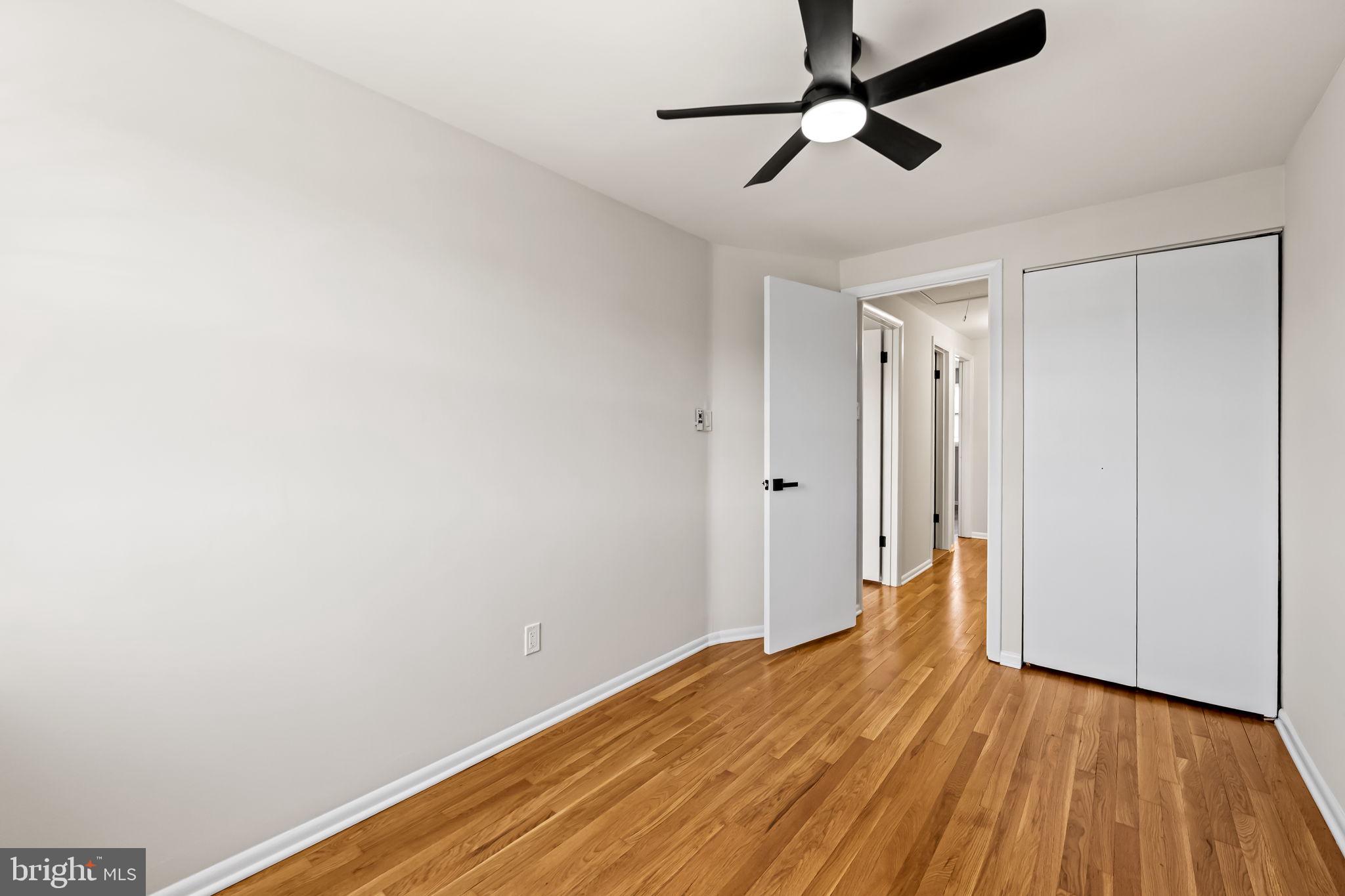 5613 Chelwynd Road Baltimore, MD 21227 - Photo 33 of 38 a view of room with hardwood floor and ceiling fan