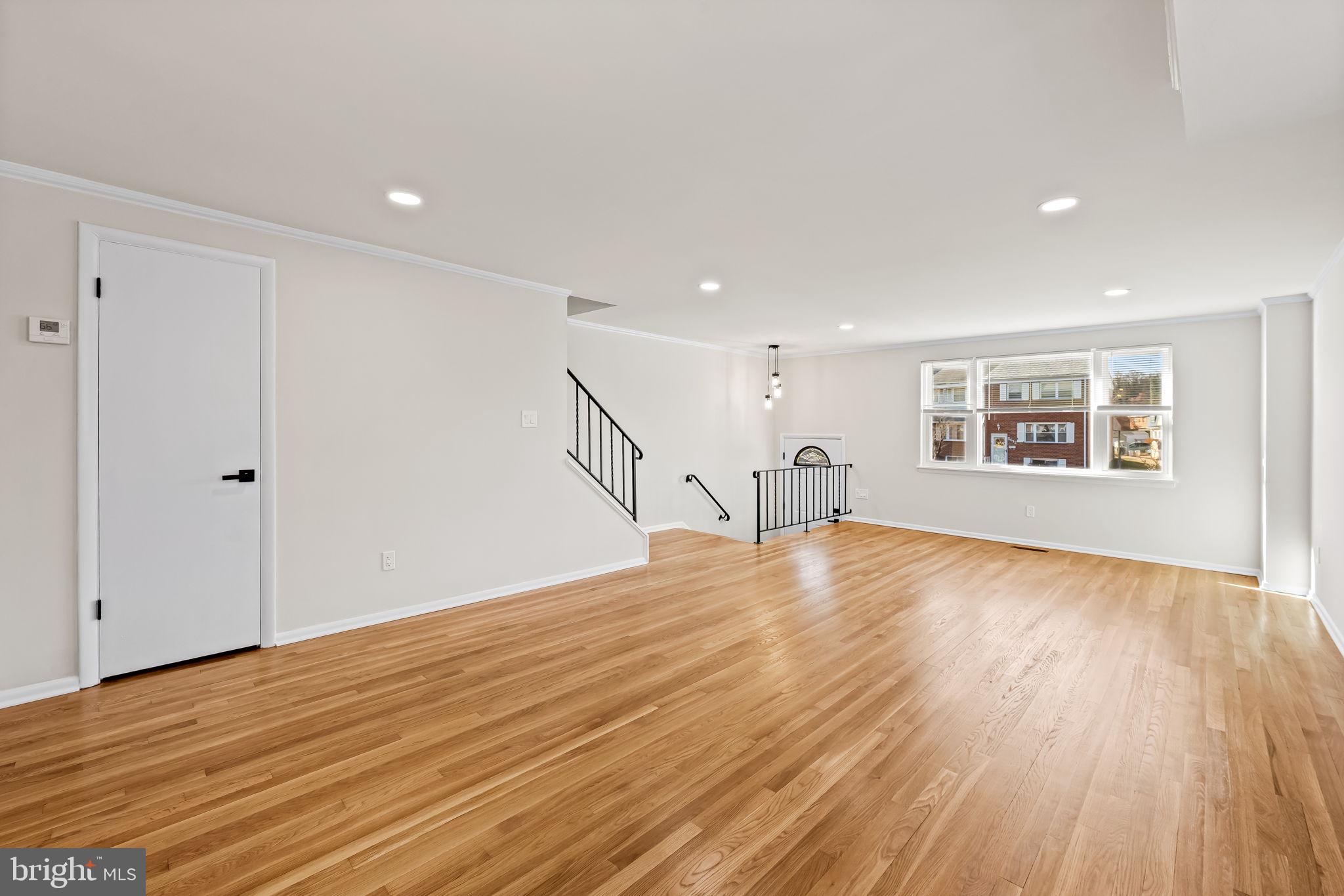 5613 Chelwynd Road Baltimore, MD 21227 - Photo 6 of 38 a view of empty room with wooden floor and fan