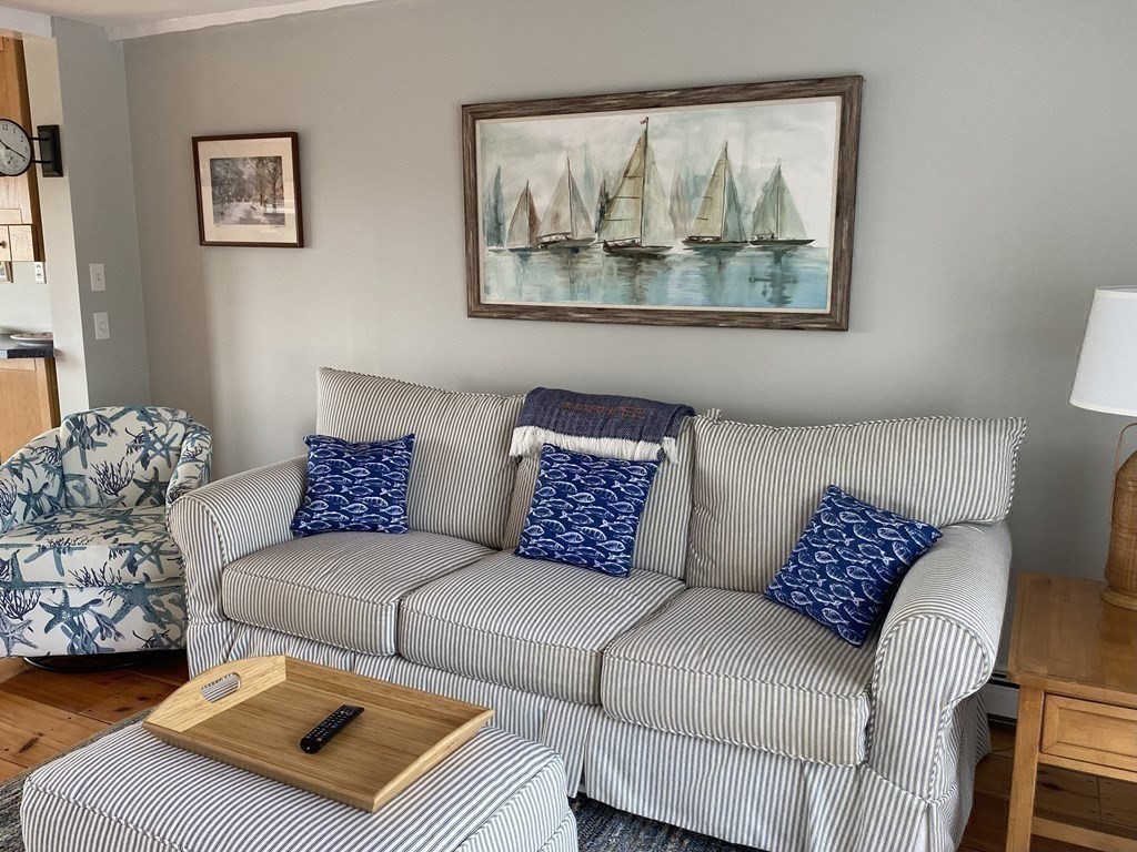 4 Race Point Road, Unit 4 Mashpee, MA 02649 - Photo 21 of 34 a living room with a couch and painting on the wall