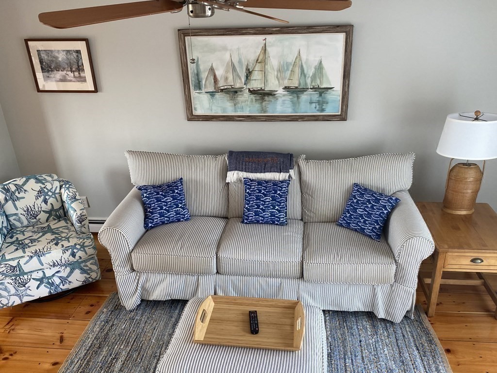 4 Race Point Road, Unit 4 Mashpee, MA 02649 - Photo 22 of 34 a living room with a couch and a wooden floor