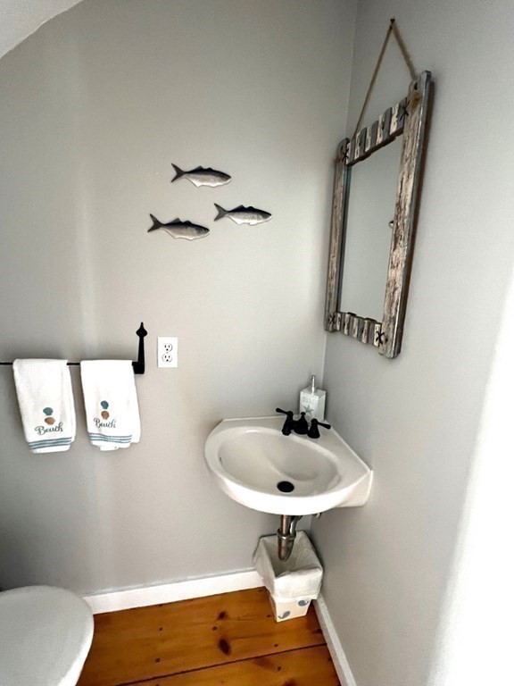 4 Race Point Road, Unit 4 Mashpee, MA 02649 - Photo 24 of 34 a bathroom with a sink and mirror