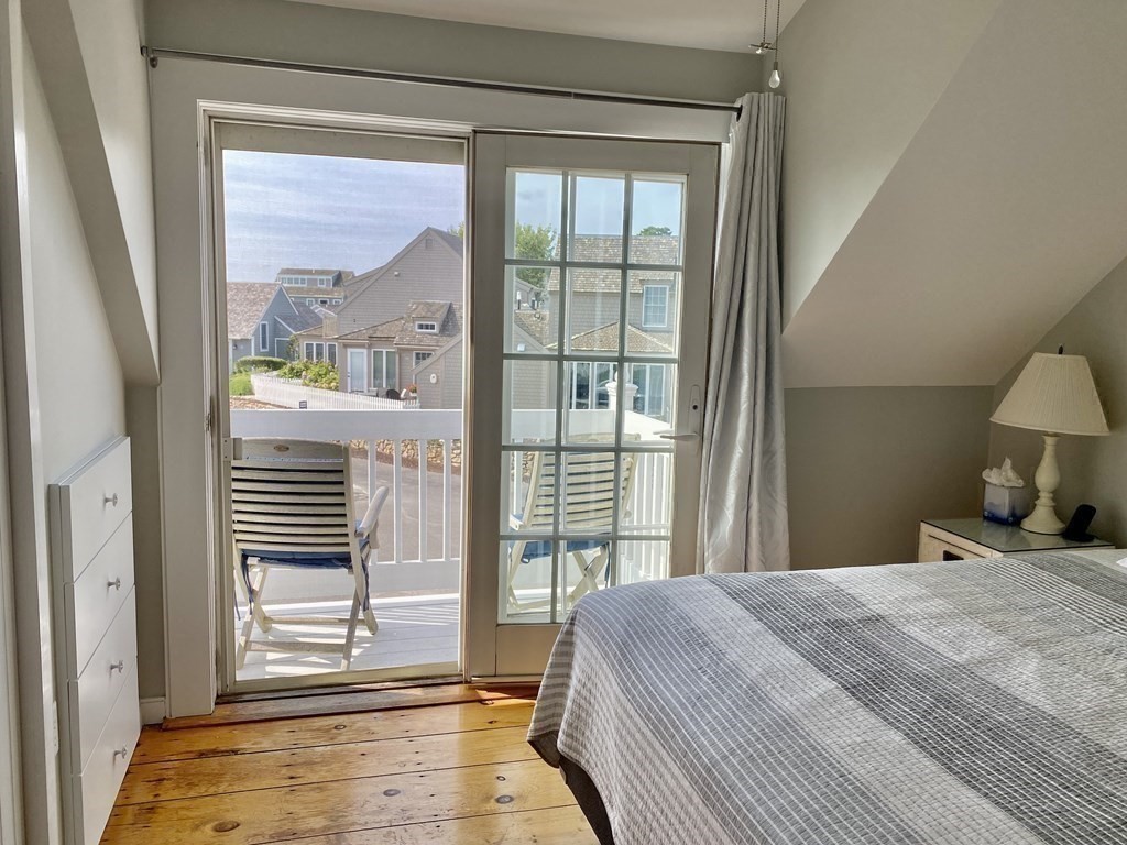4 Race Point Road, Unit 4 Mashpee, MA 02649 - Photo 27 of 34 a bedroom with a bed and a large window