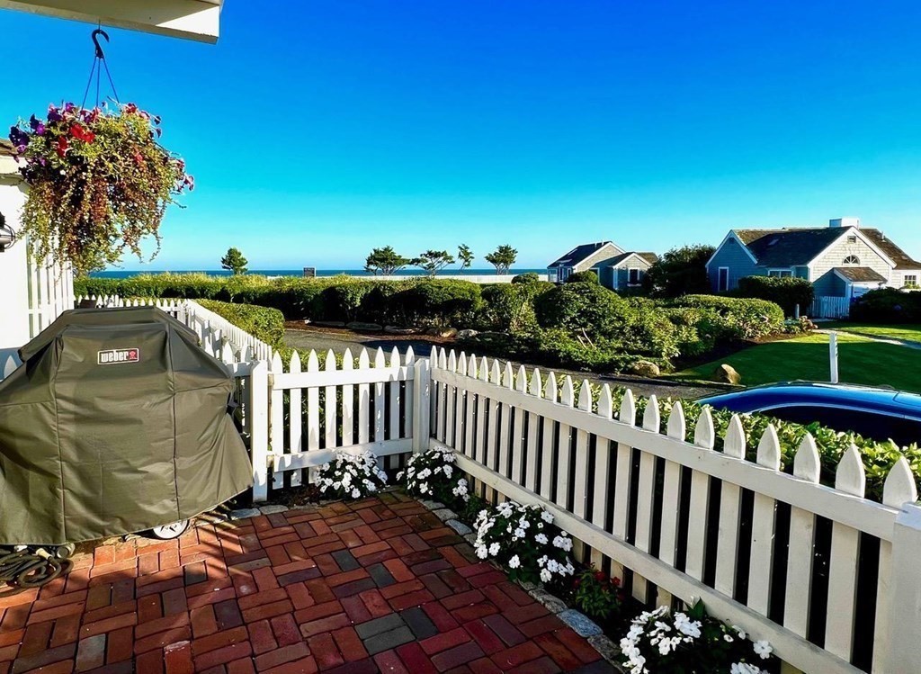 4 Race Point Road, Unit 4 Mashpee, MA 02649 - Photo 10 of 34 a view of a roof deck with wooden fence