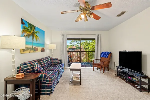 a bedroom with furniture and a flat screen tv