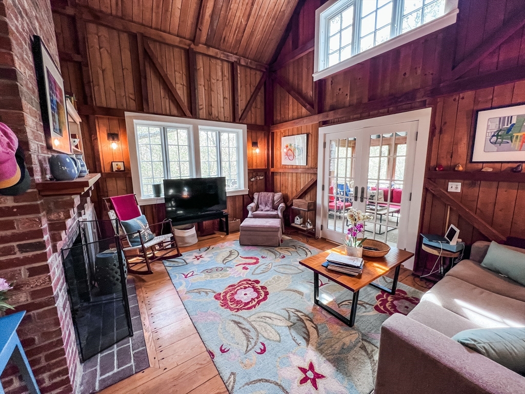 225 Lamberts Cove Road West Tisbury, MA 02568 - Photo 25 of 33 a living room with furniture a fireplace and a flat screen tv