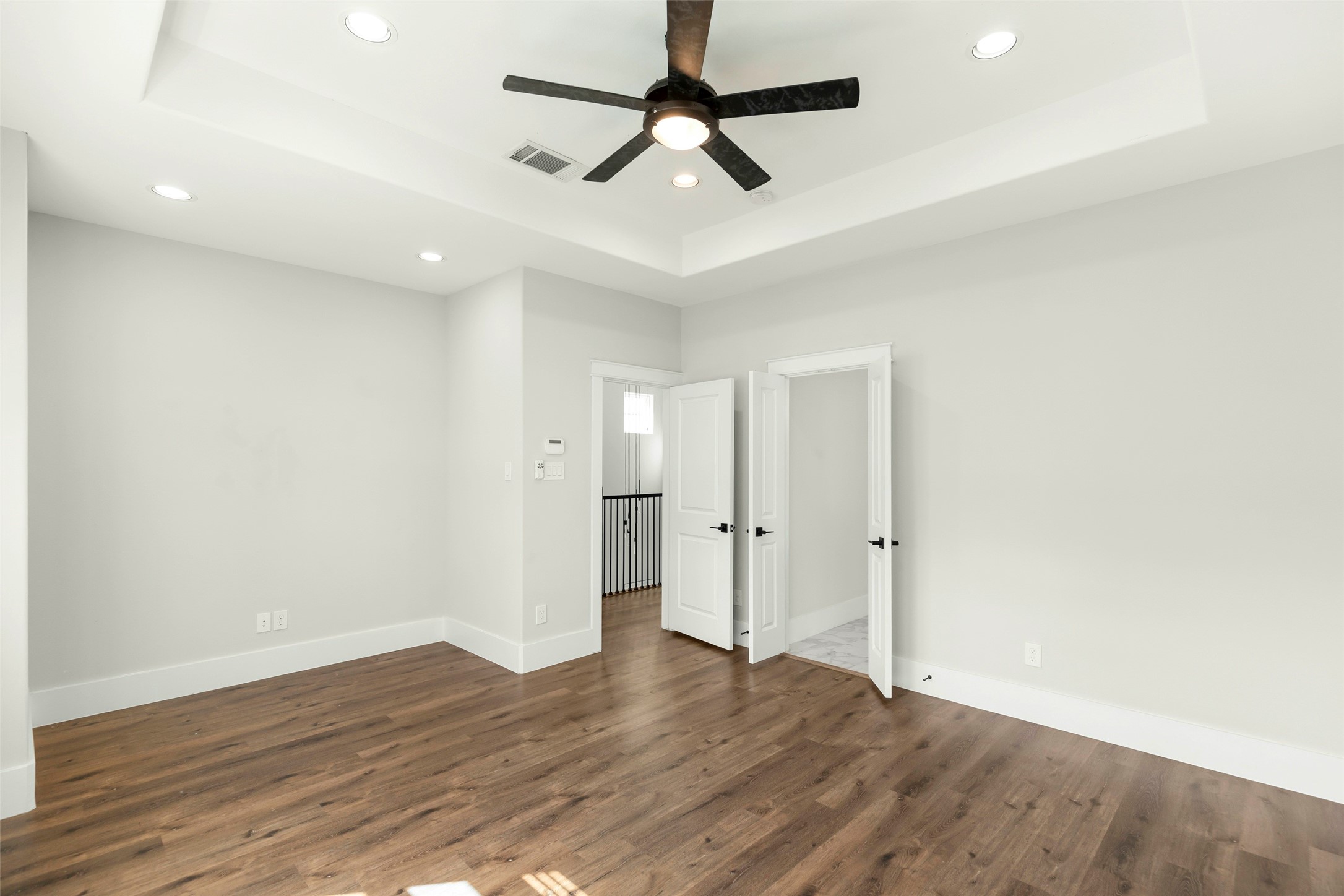 1421 West 23rd Street, Unit C Houston, TX 77008 - Photo 19 of 40 a view of room with wooden floor and ceiling fan